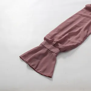 Close-up of elegant puff sleeves and flared cuffs on a dusty rose chiffon dress