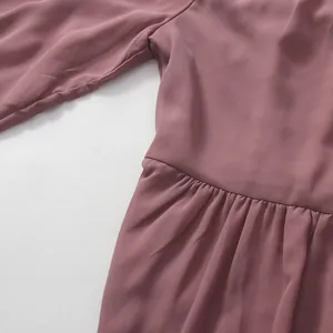 Close-up of cinched waist pleats and soft fabric texture on a mauve French style dress
