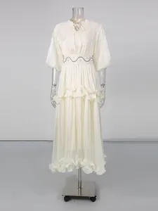 Elegant white French-style maxi dress with puff sleeves and ruffled hem for summer