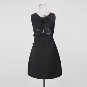 Detailed back view of black sleeveless dress with 3D flower applique and hollow design