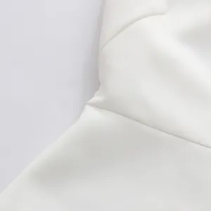 Detailed macro view showing the high-quality seam and white fabric texture of the dress