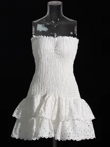 Elegant white strapless eyelet lace dress with smocked bodice and ruffled tiers