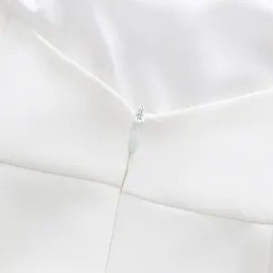 Close-up of the invisible zipper detail on a elegant white solid sleeveless dress