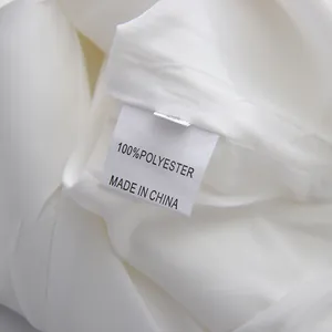 Close-up of garment care label showing 100% polyester material composition