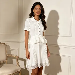 Elegant white knit peplum dress with lapel collar and delicate lace embroidery hem details.