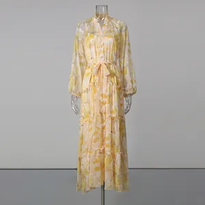 Full-length view of a yellow floral maxi dress with lantern sleeves and belted waist.