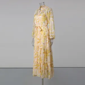 Detailed side view of yellow floral print maxi dress with lantern sleeves and belted waist