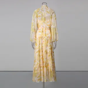 Detailed back view of a romantic yellow floral tiered maxi dress with lantern sleeves