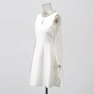 Side view of an elegant white sleeveless dress with a rhinestone-embellished neckline