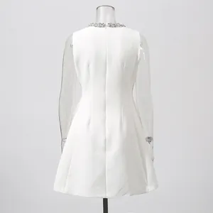 Elegant white sleeveless mini dress with rhinestone embellished collar detail.