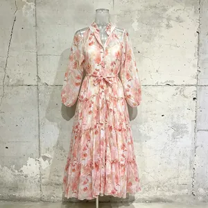 Detailed look at romantic floral pastoral maxi dress with lantern sleeves and lace-up waist