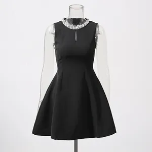 Detailed view of a black sleeveless dress featuring a luxurious rhinestone collar design.