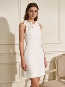 Elegant white sleeveless mini dress featuring delicate 3D floral appliques.