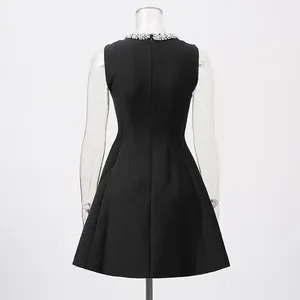 Back view of elegant black sleeveless dress with crystal-embellished round neckline