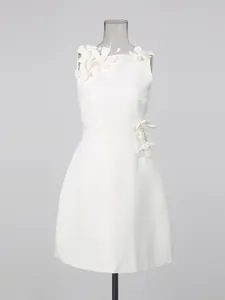 Elegant white sleeveless mini dress with 3D floral applique on shoulder and waist.