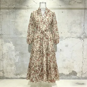 Front view of pastoral floral dress with V-neck, lantern sleeves, and belted waist
