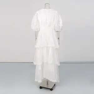 Back view of vintage white puff sleeve tiered dress with delicate lace trim details