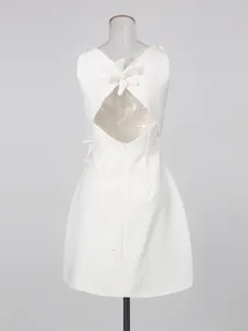 Elegant white sleeveless dress with 3D flower applique and stylish back cutout detail