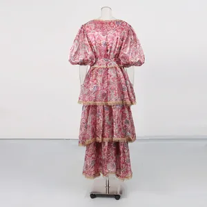 Detailed back view of a vintage floral tiered maxi dress featuring golden lace trim details