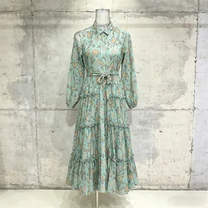 Detailed shot of a pastoral tiered teal maxi dress with shirt collar and lantern sleeves