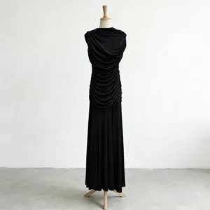Close-up detail of an elegant ruched sleeveless black maxi dress with draped design