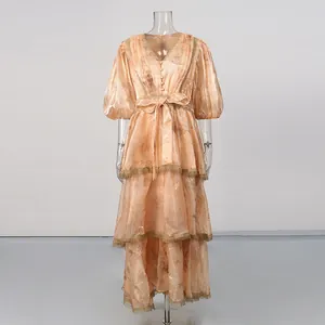 Close-up of retro floral tiered dress with delicate lace trim and V-neckline details