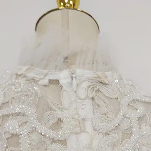 Close-up detail of white water-soluble lace dress with invisible back zipper