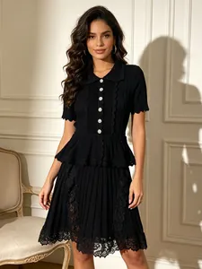 Elegant black polo collar knit dress with ruffle waist and lace embroidery detail.