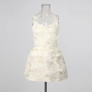 Detailed view of white lace mini dress featuring 3D butterfly floral embroidery appliques