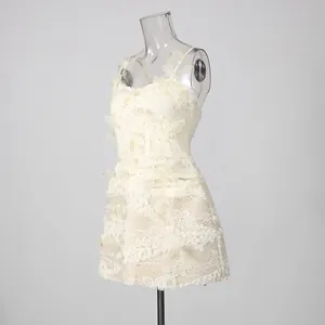 Detailed view of white lace dress featuring delicate 3D butterfly appliqués