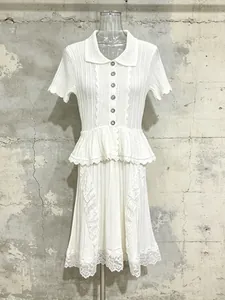 Elegant white knitted short-sleeve dress featuring lapel collar and lace ruffled hem.
