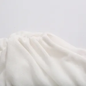 Close-up detail of the gathered fabric texture on an elegant white French style dress