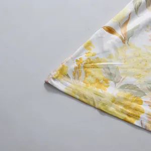 Macro view of the yellow floral pattern and neat hem stitching on a romantic pastoral dress