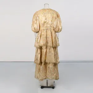 Back view of a vintage yellow tiered maxi dress with lace trim and puffed sleeves.