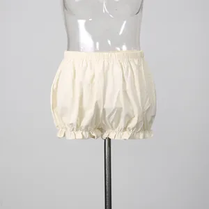 Detailed view of cream-colored ruffled bloomers featuring an elastic waistband on mannequin