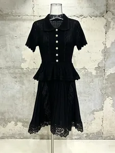 Elegant black knit dress with pearl buttons, peplum waist, and lace hem detail
