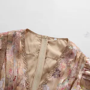 Close-up detail of V-neck lace trim and floral print on a retro style dress