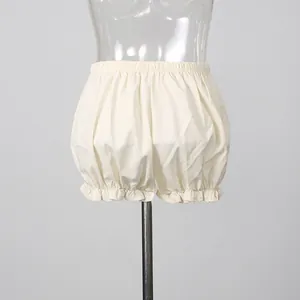 Cream cotton bloomer shorts with ruffled hems shown on a mannequin in a detail studio shot