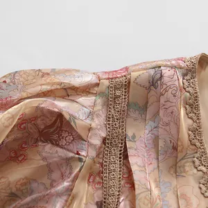 Close-up of vintage floral print maxi dress featuring intricate beige lace embroidery detail.