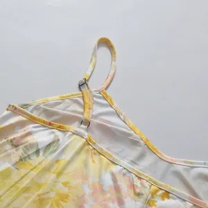 Detailed close-up showing the adjustable shoulder strap and yellow floral print of this dress