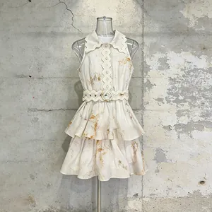 Elegant sleeveless mini dress with scalloped collar and belted tiered skirt detail