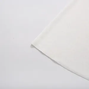 Detailed macro view showing the high-quality white knitted fabric texture of an elegant dress