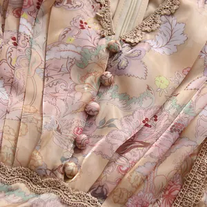 Macro detail of a vintage floral dress featuring lace trim and fabric covered buttons
