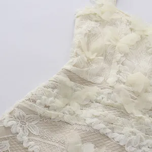 Close-up of intricate lace embroidery and 3D butterfly appliqués on elegant dress