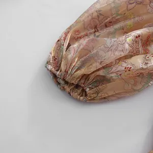 Close-up of elegant puff sleeve cuff on vintage floral printed dress with silk texture
