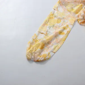 Close-up of yellow floral lantern sleeve with elastic cuff on a romantic pastoral dress