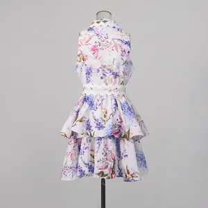 Detail of sleeveless floral mini dress with scalloped collar and tiered ruffle hem.