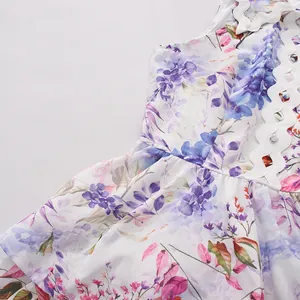 Close-up detail of a sweet floral sleeveless dress with white wavy trim and buttons.