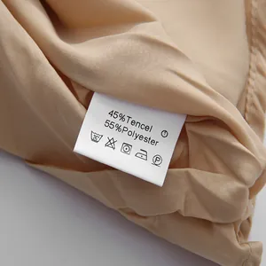 Detail shot of care label showing 45% Tencel and 55% Polyester fabric composition