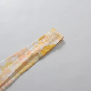 Close-up of the yellow floral pattern and chiffon fabric texture of a romantic dress